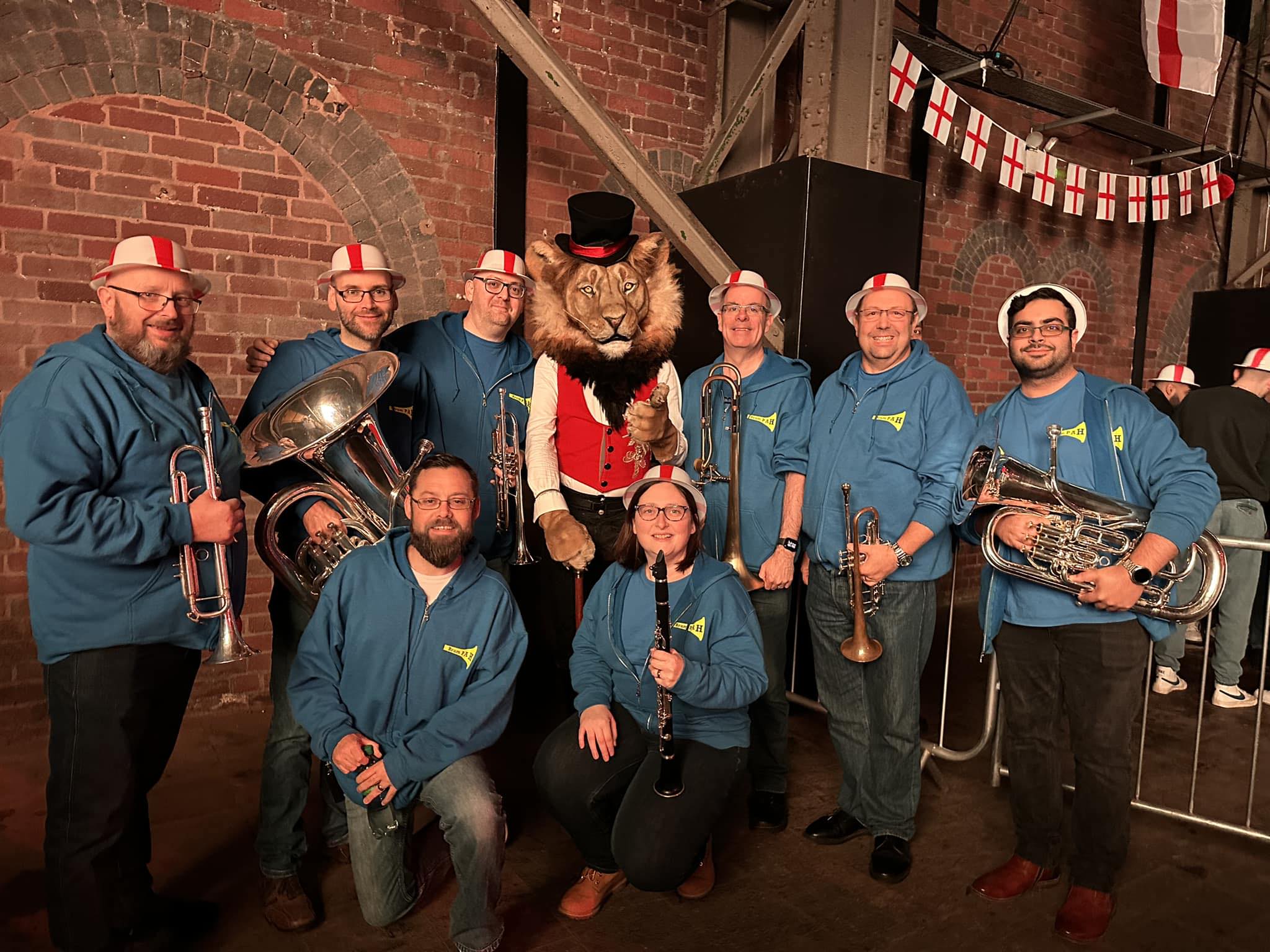 Young man with dark hair and beard, brown eyes, blue t-shirt